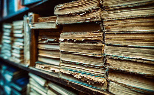 Old books being stored in a library as archives